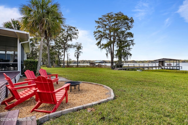 view of yard featuring an outdoor fire pit and a water view