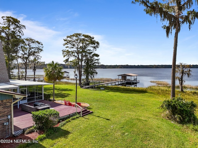 dock area with a water view and a yard