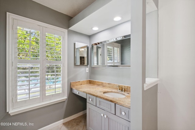 bathroom featuring vanity, a textured ceiling, and tile patterned floors