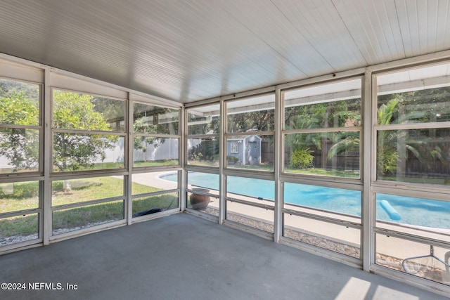 unfurnished sunroom with lofted ceiling