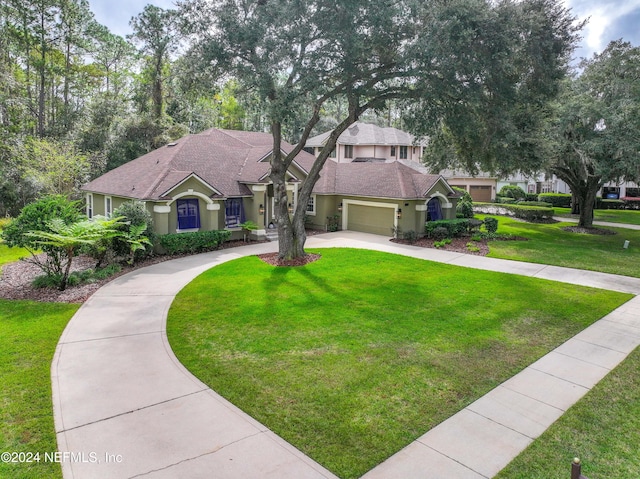 view of front of home with a front yard and a garage