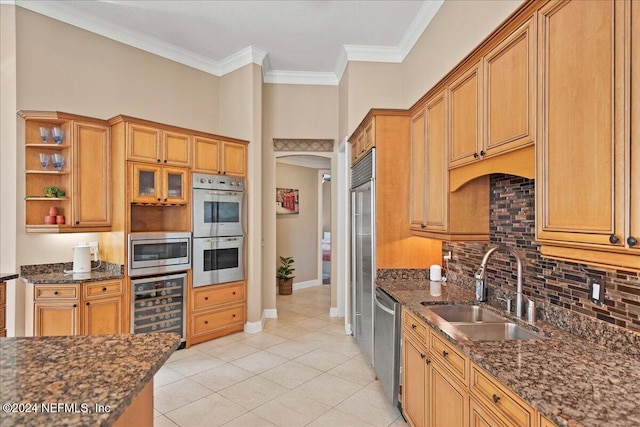 kitchen featuring sink, wine cooler, dark stone counters, light tile patterned floors, and appliances with stainless steel finishes