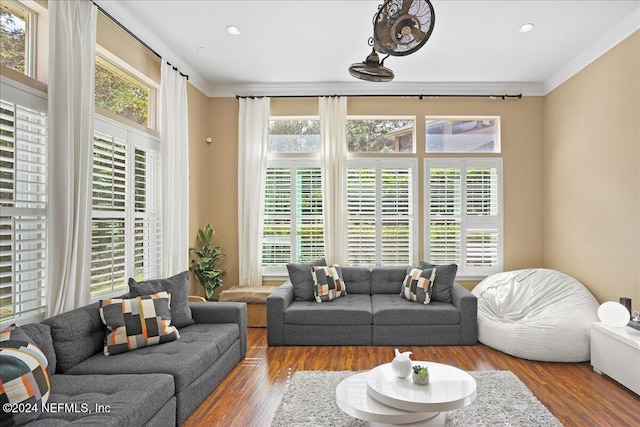 living room with crown molding and hardwood / wood-style flooring