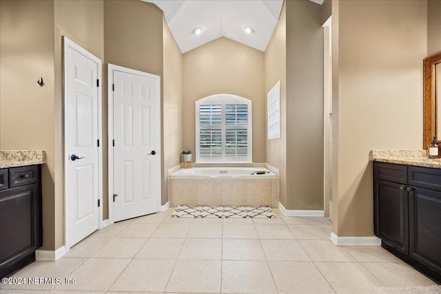 bathroom with tile patterned floors, vanity, a relaxing tiled tub, and high vaulted ceiling