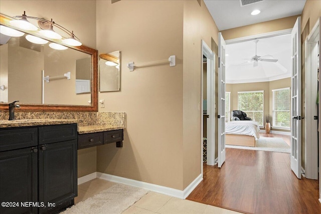 bathroom featuring wood-type flooring, vanity, and ceiling fan