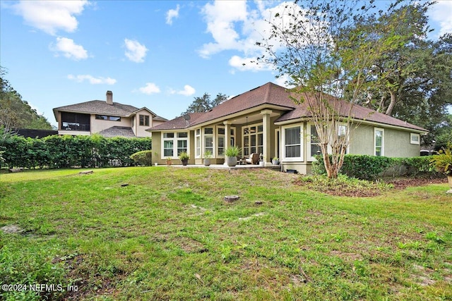 rear view of house with a yard