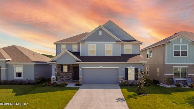 craftsman inspired home featuring a garage and a yard