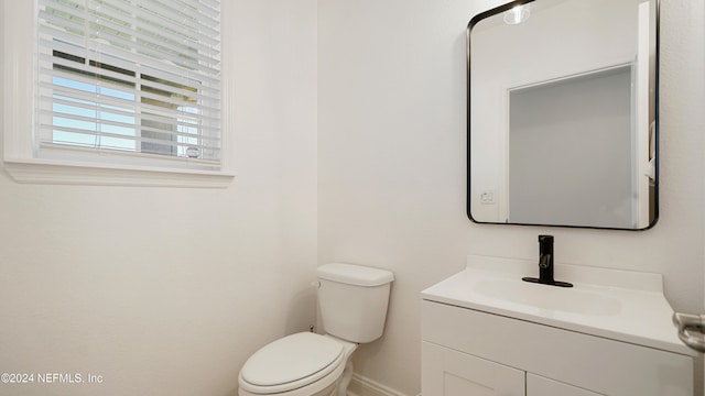 bathroom with toilet and vanity