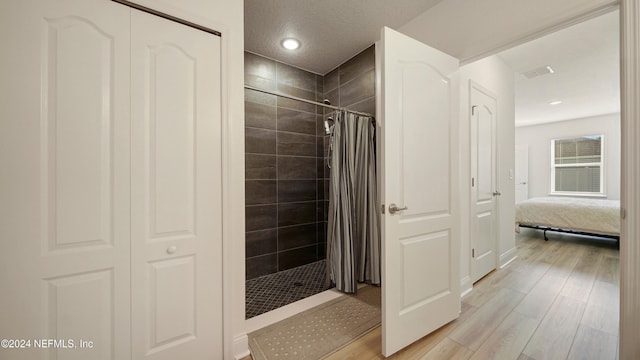 bathroom featuring hardwood / wood-style flooring and curtained shower