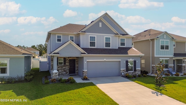 craftsman inspired home with a garage and a front yard