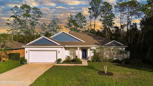 view of front facade with a garage and a lawn