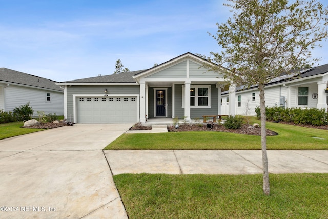 view of front of home with a front yard, a garage, and covered porch