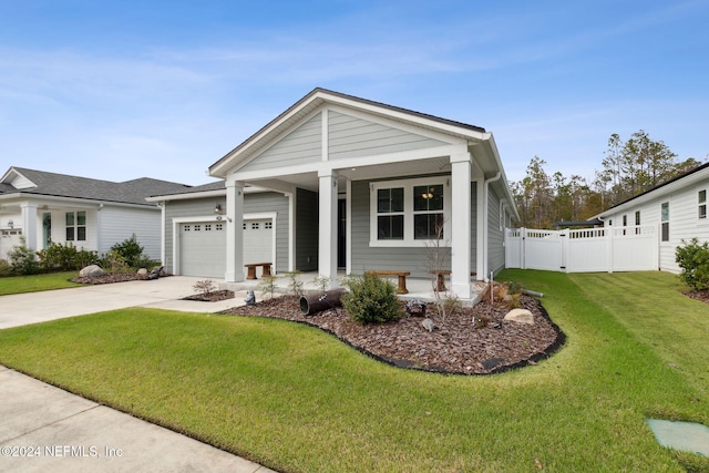 view of front of house featuring a porch, a garage, and a front lawn