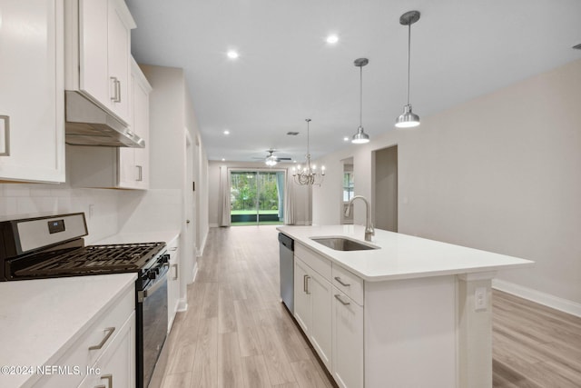 kitchen featuring a center island with sink, sink, white cabinetry, and stainless steel appliances