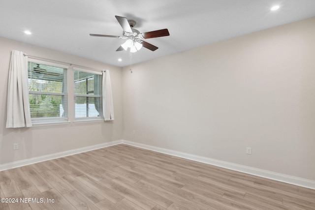 spare room featuring ceiling fan and light wood-type flooring