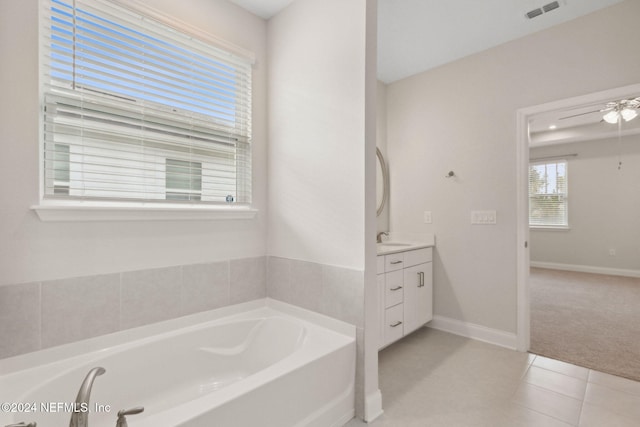 bathroom featuring tile patterned flooring, vanity, a bathtub, and ceiling fan