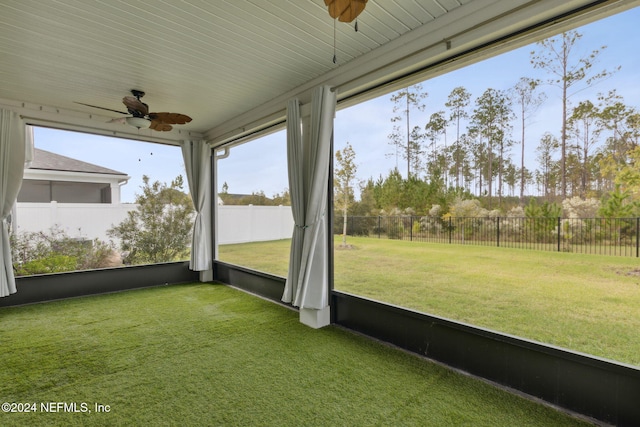 unfurnished sunroom featuring ceiling fan