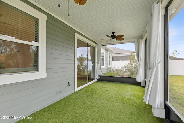 unfurnished sunroom featuring ceiling fan