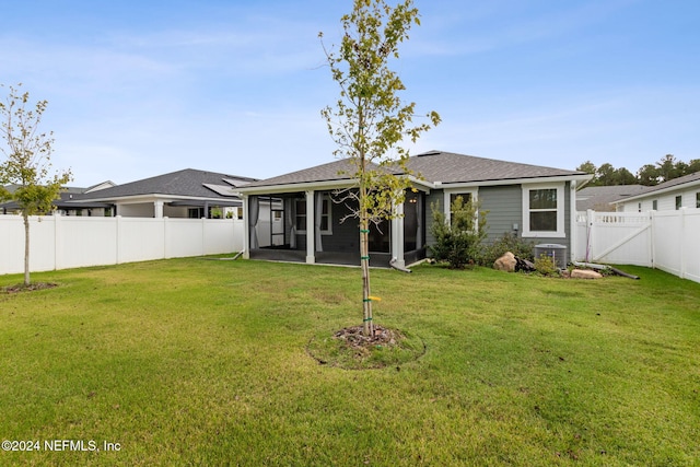 rear view of property with a yard, a patio, and central AC unit