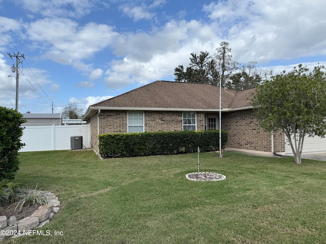 ranch-style home with central air condition unit and a front yard