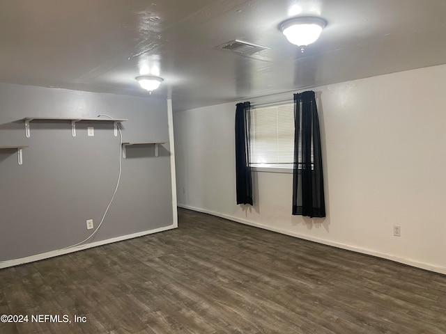 empty room with dark hardwood / wood-style floors