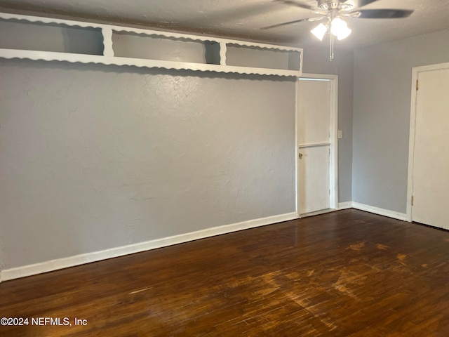 spare room featuring dark hardwood / wood-style floors and ceiling fan