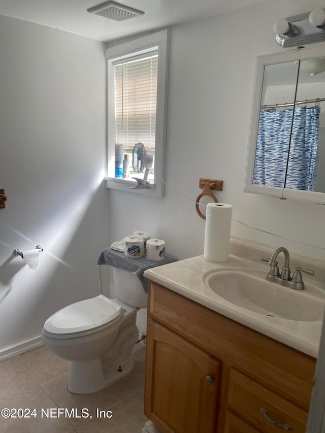 bathroom with vanity, toilet, and tile patterned floors