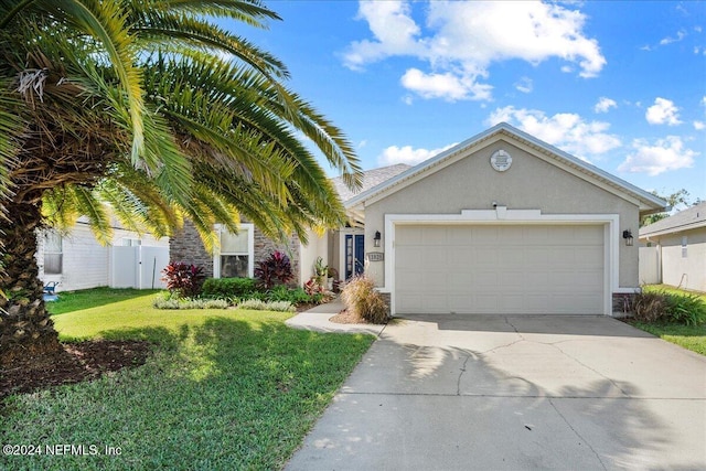 view of front of house with a garage and a front lawn