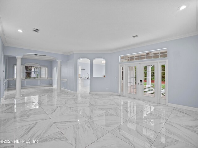 spare room with ornamental molding, french doors, and ornate columns