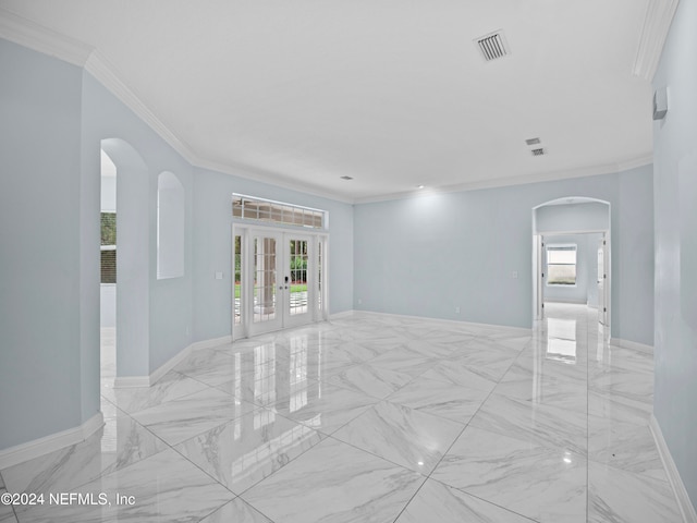 spare room featuring ornamental molding and french doors