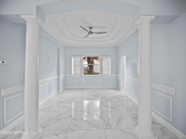 unfurnished room with ornamental molding, ceiling fan, and decorative columns