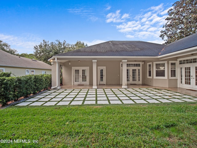 back of property featuring a patio area, french doors, and a yard