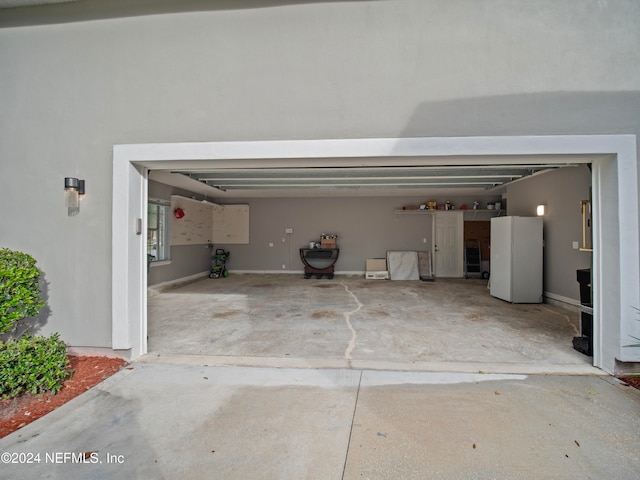 garage featuring white fridge