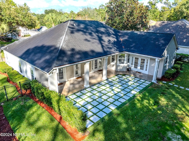 rear view of house featuring french doors, a patio, and a yard