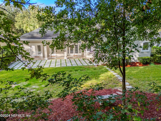 view of yard featuring a patio and french doors