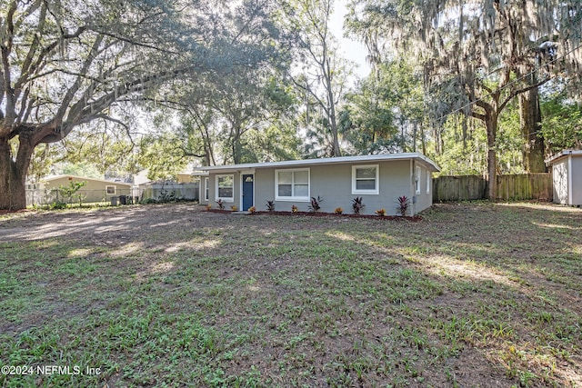 single story home featuring a front lawn