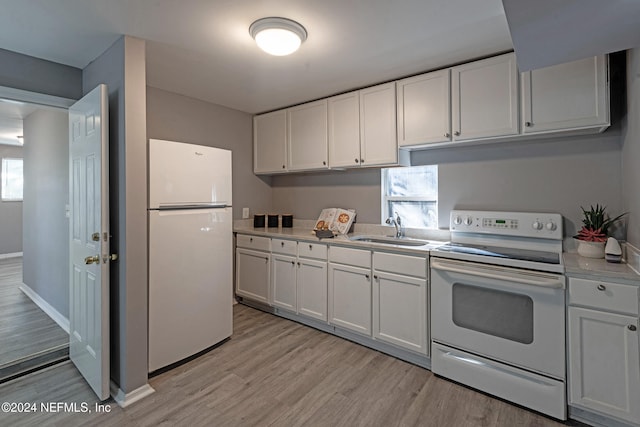 kitchen with white appliances, white cabinetry, sink, and light wood-type flooring