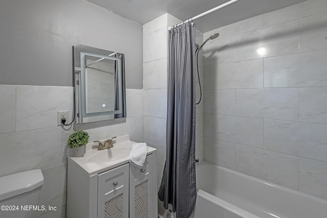 full bathroom featuring tile walls, vanity, shower / bath combo with shower curtain, and toilet