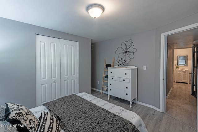 bedroom with a closet and light wood-type flooring