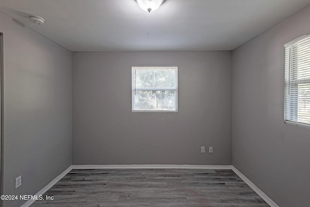 empty room featuring hardwood / wood-style floors and plenty of natural light