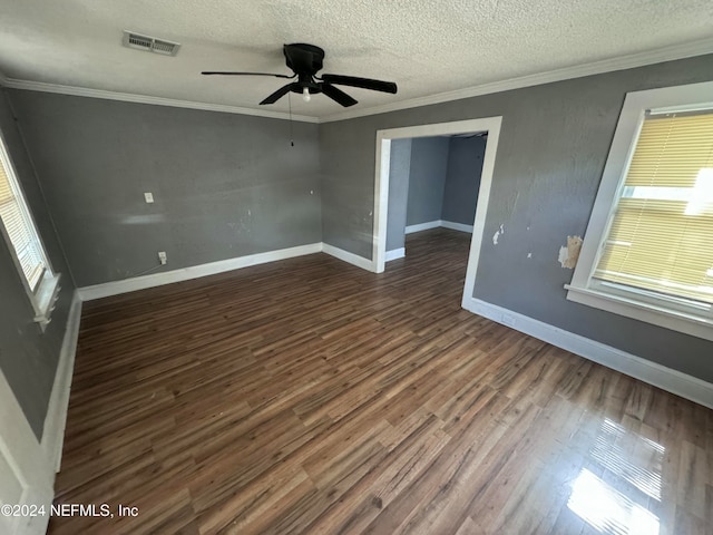 spare room featuring ceiling fan, a textured ceiling, dark hardwood / wood-style flooring, and ornamental molding