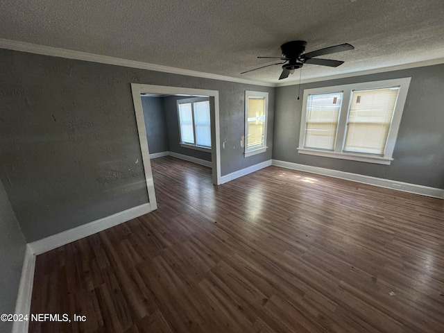 empty room featuring ceiling fan, a textured ceiling, ornamental molding, and dark hardwood / wood-style flooring