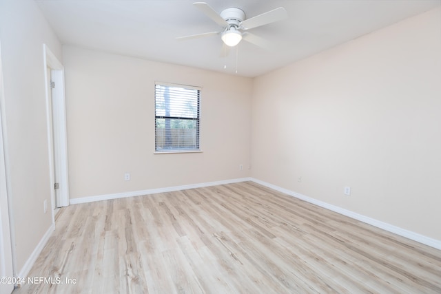 spare room featuring light hardwood / wood-style floors and ceiling fan