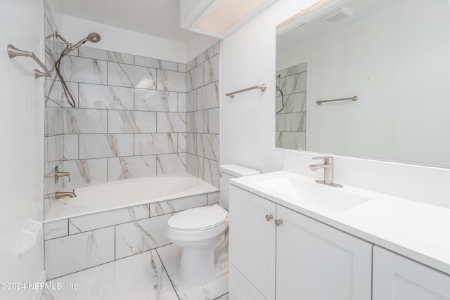 full bathroom featuring toilet, tiled shower / bath combo, and vanity