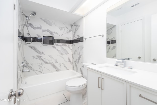 full bathroom with tiled shower / bath, vanity, and toilet