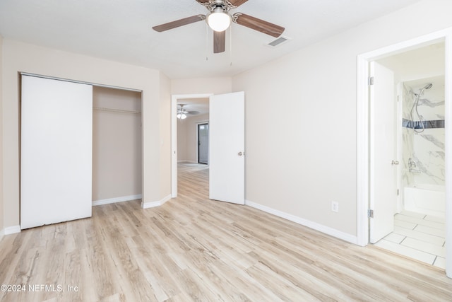 unfurnished bedroom with ensuite bathroom, light hardwood / wood-style flooring, ceiling fan, and a closet