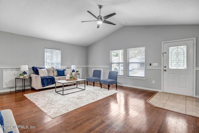 living room featuring ceiling fan, lofted ceiling, and dark hardwood / wood-style floors