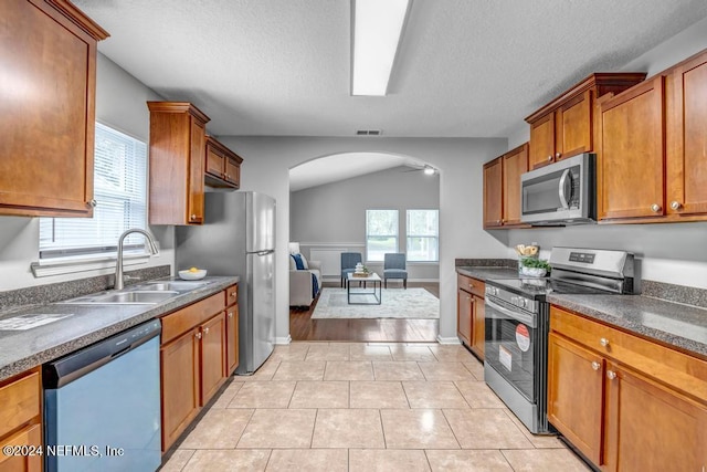 kitchen featuring sink, appliances with stainless steel finishes, a healthy amount of sunlight, and light tile patterned flooring