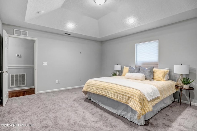 bedroom with a textured ceiling and carpet floors