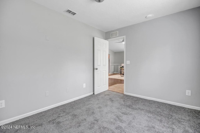 carpeted empty room featuring ceiling fan